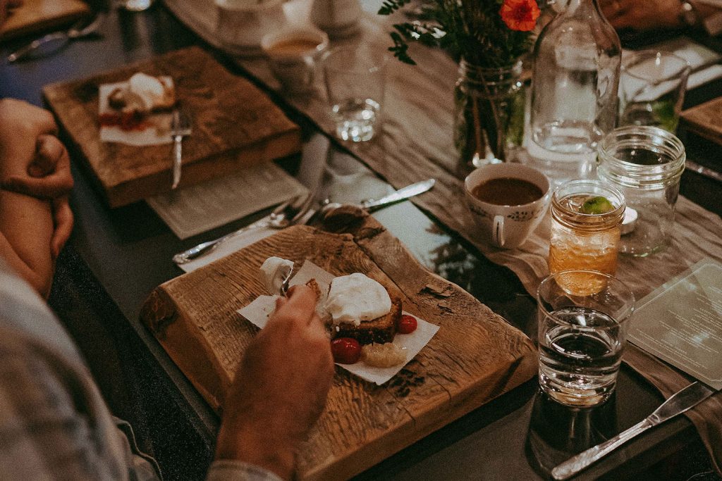 A beautifully curated place setting with a meal served on a wooden board